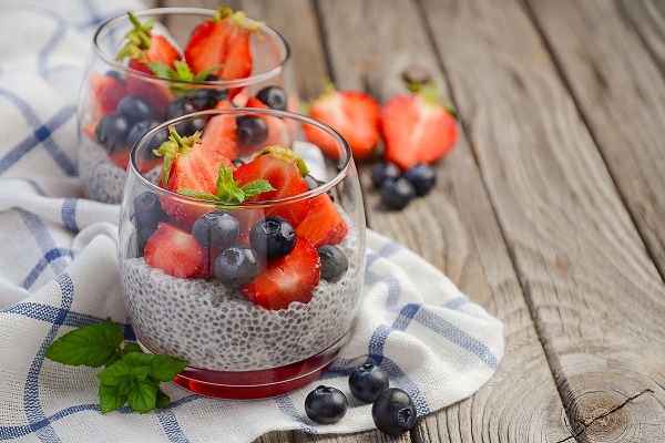 Chia seed pudding with strawberries and blueberries, selective focus, copy space